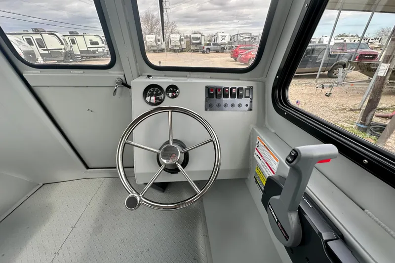 Slide: The Image of Interior view of 2026 SeaArk 2472 CUB boat cockpit with steering wheel and controls. - 25
