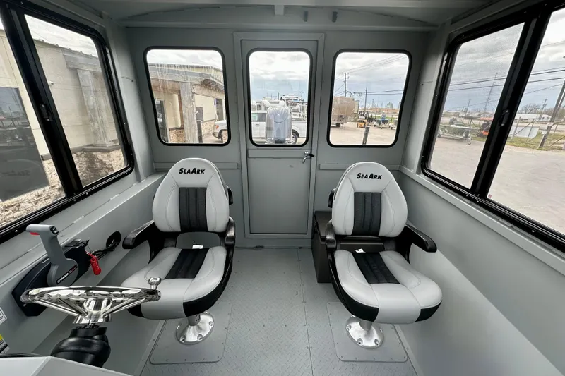 Slide: The Image of Interior of 2026 SeaArk 2472 CUB boat with two seats and steering controls. - 26
