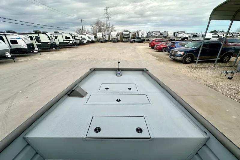 Slide: The Image of 2026 SeaArk 2472 CUB boat in a dealership lot with RVs and cars. - 27