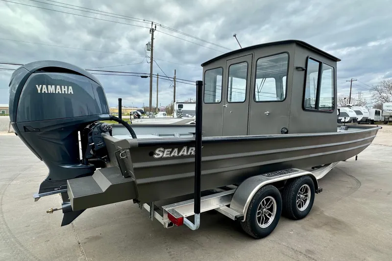 Slide: The Image of 2026 SeaArk 2472 CUB boat with Yamaha engine on a trailer, parked outdoors. - 4