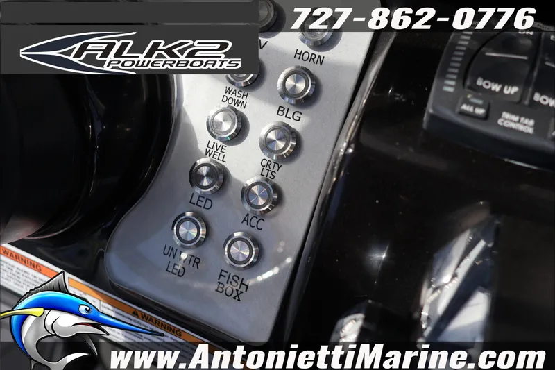 Slide: The Image of Control panel of 2026 ALK2 Powerboats 25 CRXL with various switches and branding. - 10