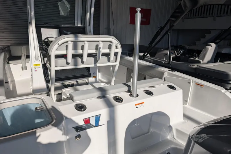 Slide: The Image of 2026 Wellcraft 223 Fisherman boat interior with seating and fishing rod holders. - 14