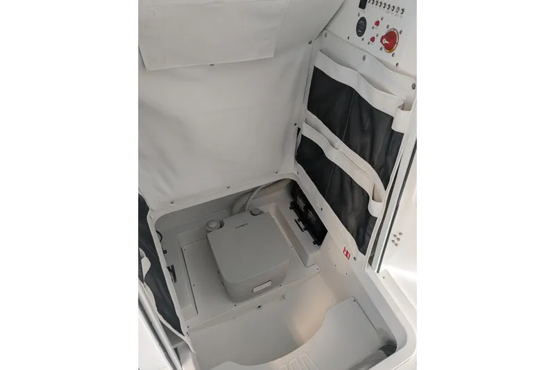 Slide: The Image of Interior of 2026 Wellcraft 223 Fisherman boat, featuring storage compartments and control panel. - 9