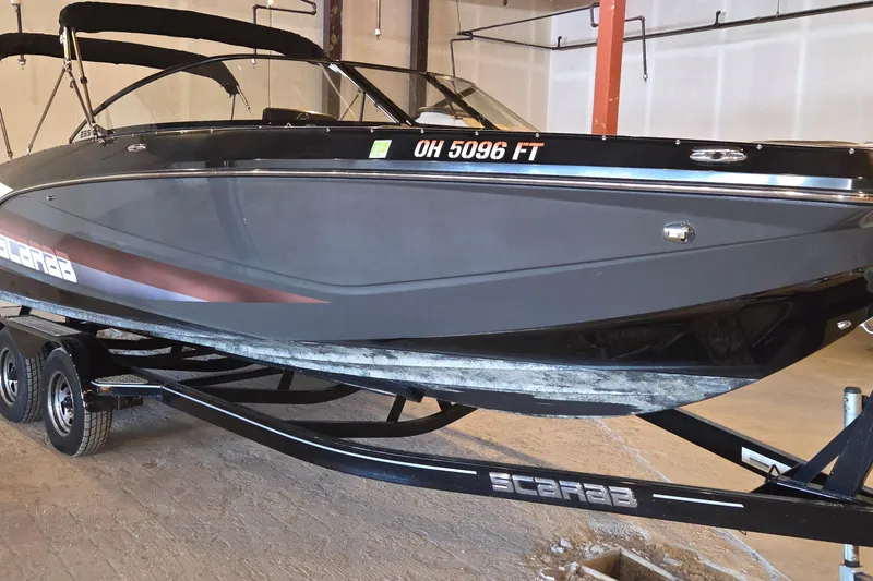 The Image of 2018 Scarab 255 boat on trailer in indoor storage facility. - 0