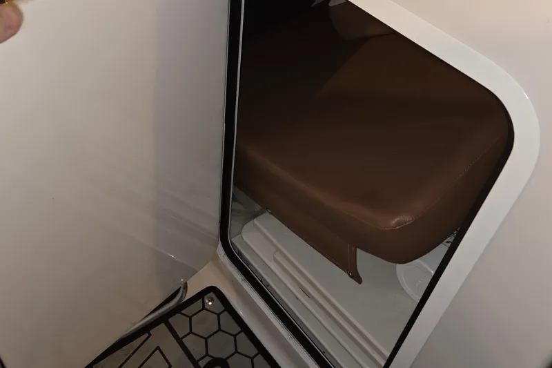 Slide: The Image of Interior view of 2018 Scarab 255 boat cabin with brown seating. - 10