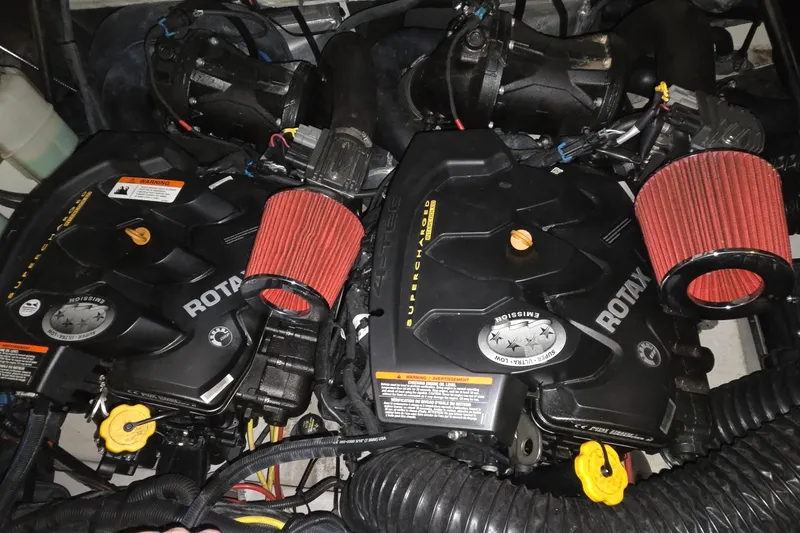 Slide: The Image of Dual Rotax engines in a 2018 Scarab 255 boat, featuring red air filters. - 14