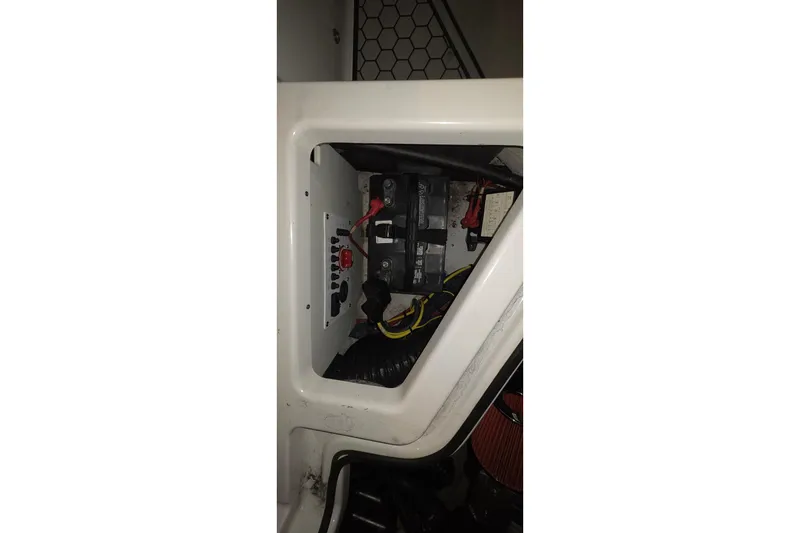 Slide: The Image of Interior view of a 2018 Scarab 255 boat's battery compartment with wiring. - 15