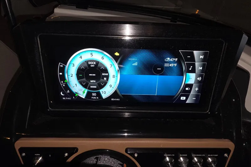 Slide: The Image of Dashboard display of a 2018 Scarab 255 boat showing speedometer and controls. - 18