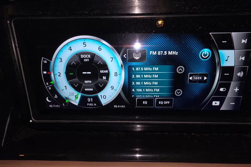 Slide: The Image of Dashboard display of a 2018 Scarab 255 showing speedometer and FM radio settings. - 21