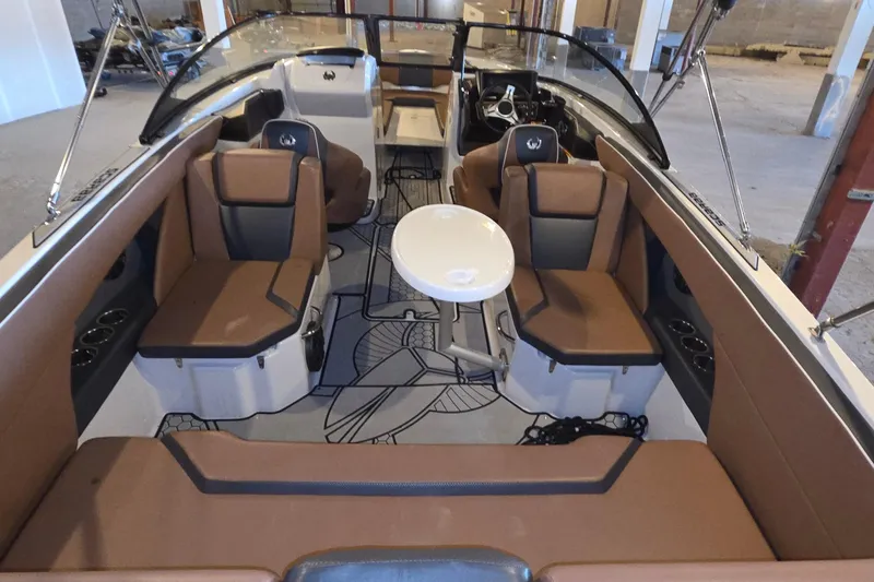 Slide: The Image of 2018 Scarab 255 boat interior with brown seating and a central table. - 6