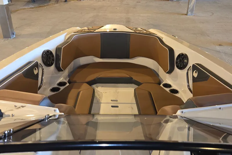 Slide: The Image of Interior of 2018 Scarab 255 boat with brown seating and built-in speakers. - 7