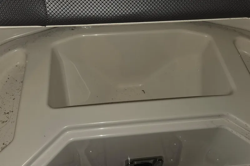 Slide: The Image of Storage compartment of 2018 Scarab 255 boat, featuring a clean, beige interior. - 9