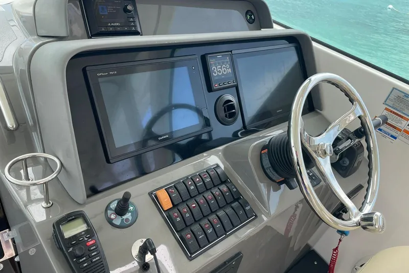 Slide: The Image of Helm of 2018 Pursuit OS 385 Offshore boat with Garmin navigation system and steering wheel. - 4