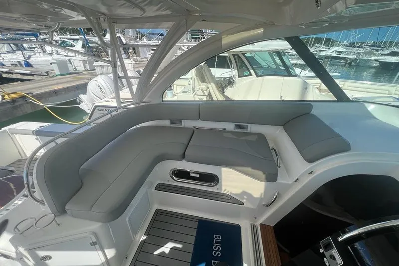 Slide: The Image of 2018 Pursuit OS 385 Offshore boat interior with gray seating at marina. - 5