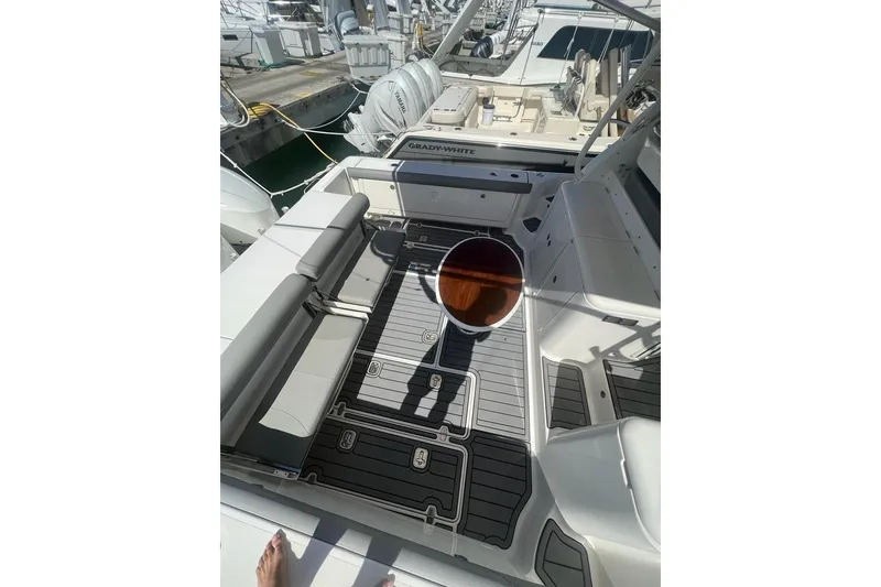 Slide: The Image of 2018 Pursuit OS 385 Offshore boat interior with seating and deck view. - 7