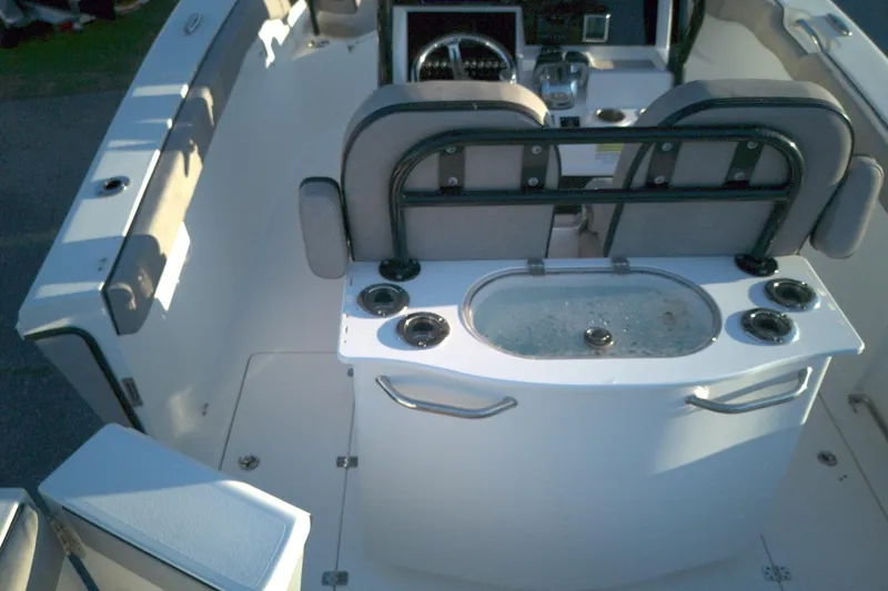 Slide: The Image of 2021 Sea Pro 259 Center Console boat interior with seating and control panel. - 11