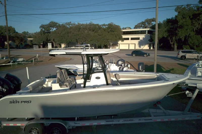Slide: The Image of 2021 Sea Pro 259 Center Console boat on trailer, parked outdoors. - 12