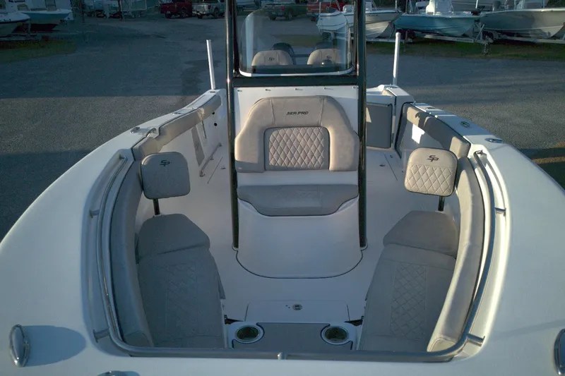 Slide: The Image of 2021 Sea Pro 259 Center Console boat interior with cushioned seating and console. - 9