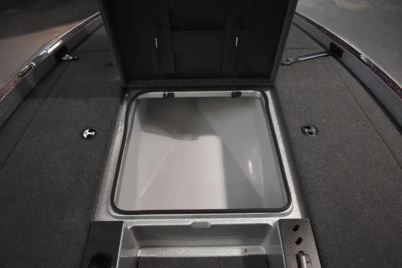 Slide: The Image of Open storage compartment on 2026 Triton 18 TrX boat deck. - 10