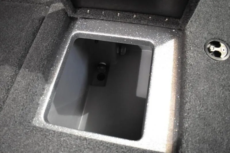 Slide: The Image of Storage compartment in 2026 Triton 18 TrX boat, featuring a secure, carpeted interior. - 18