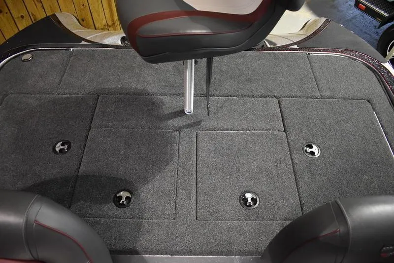 Slide: The Image of 2026 Triton 18 TrX boat interior with carpeted deck and seating. - 21