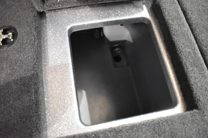 Slide: The Image of Storage compartment in 2026 Triton 18 TrX boat, featuring a carpeted interior. - 8