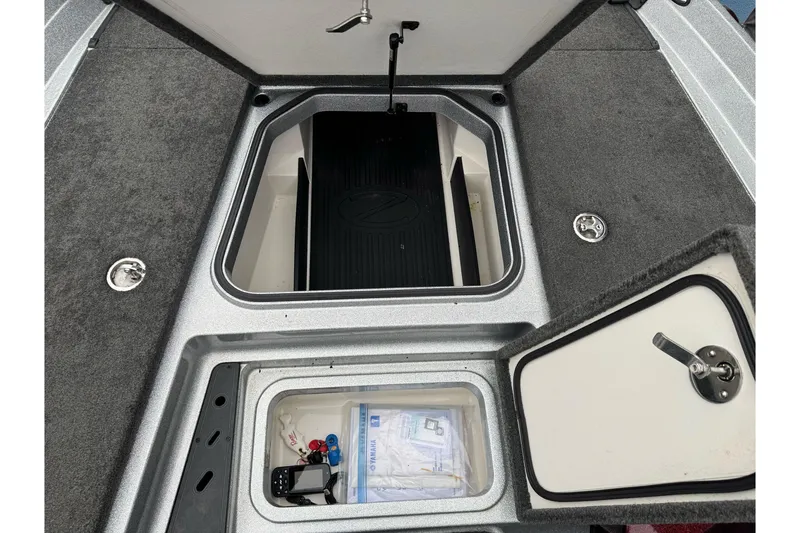 Slide: The Image of 2017 Ranger Z175 boat storage compartments with carpeted interior and secure latches. - 10