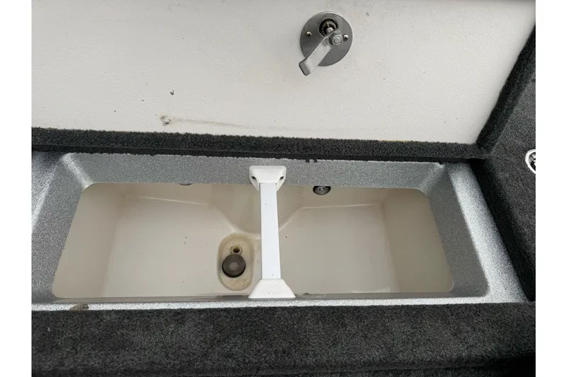 Slide: The Image of 2017 Ranger Z175 boat storage compartment with latch, open and empty. - 15