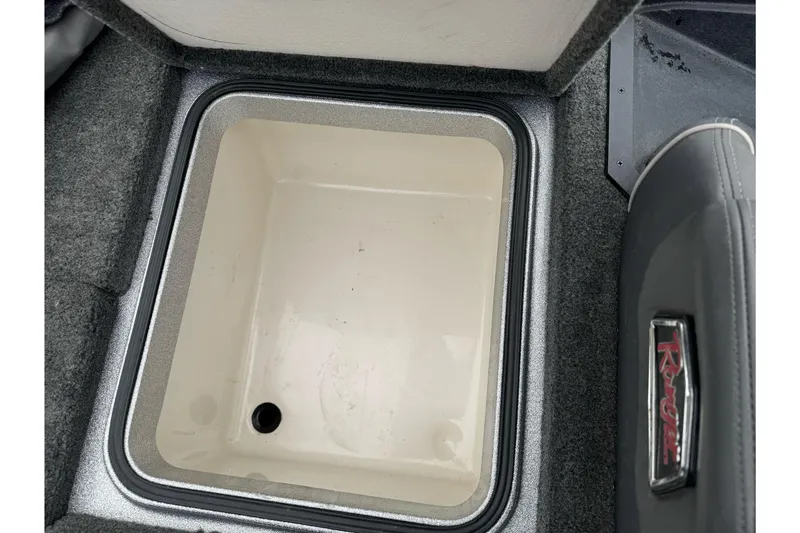 Slide: The Image of 2017 Ranger Z175 boat storage compartment with open lid, featuring a clean interior. - 16