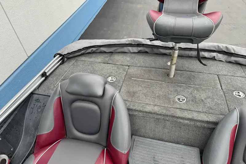 Slide: The Image of 2017 Ranger Z175 boat interior with gray and red seating, carpeted deck. - 18