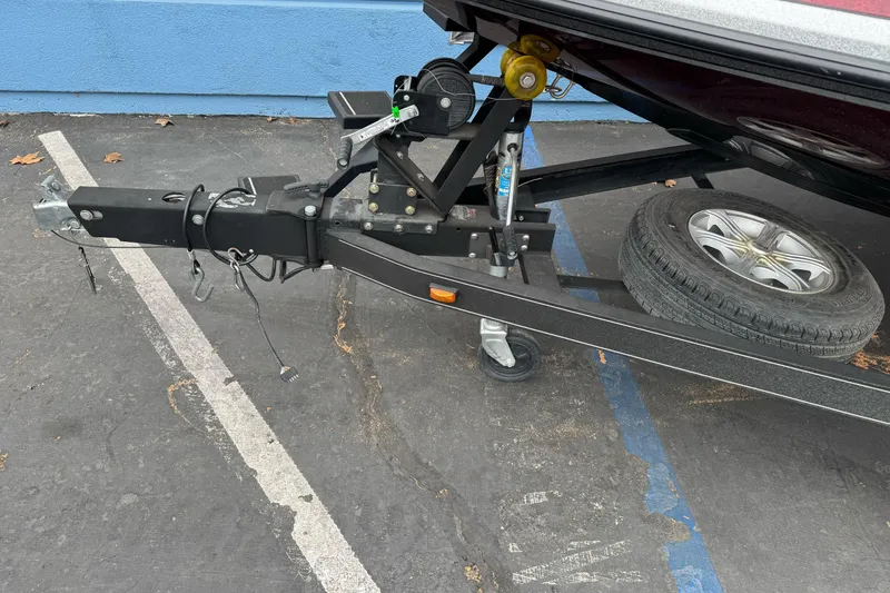 Slide: The Image of Trailer hitch and spare tire of 2017 Ranger Z175 boat on pavement. - 2