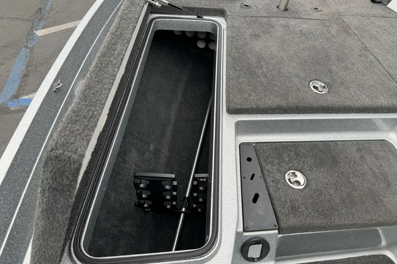 Slide: The Image of 2017 Ranger Z175 boat storage compartment with open lid and carpeted interior. - 9