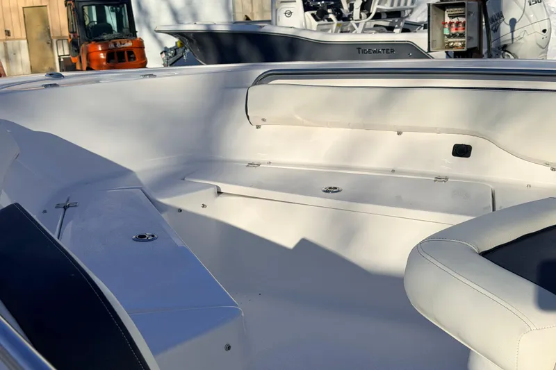 Slide: The Image of 2026 Tidewater 198 CC Adventure boat interior with white seating and storage compartments. - 11