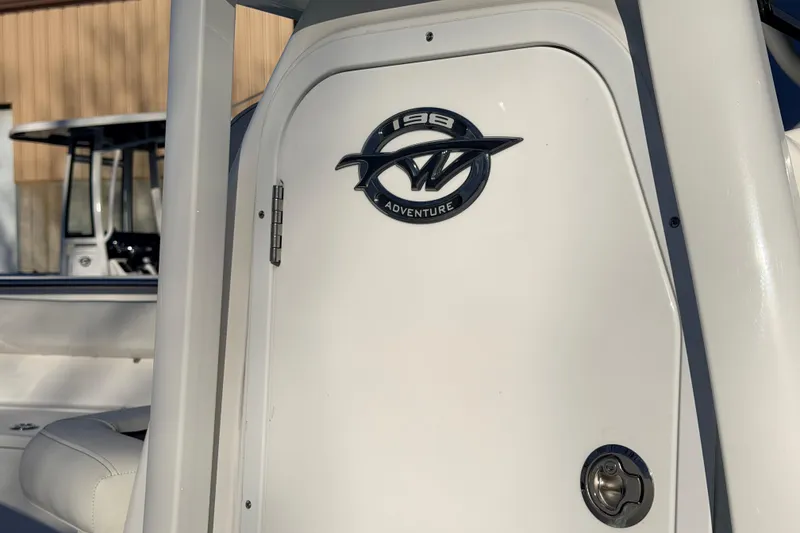 Slide: The Image of 2026 Tidewater 198 CC Adventure boat, close-up of logo and sleek design. - 13