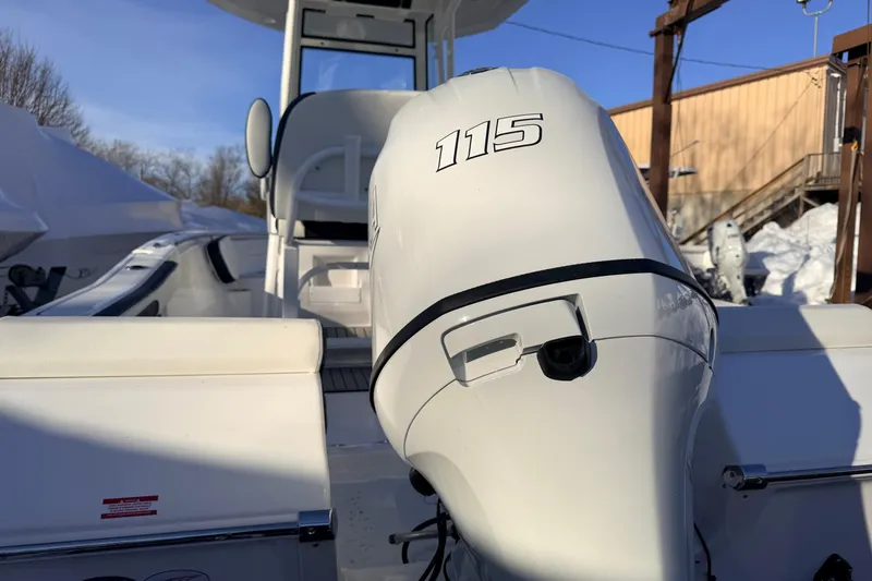 Slide: The Image of 2026 Tidewater 198 CC Adventure boat with 115 HP engine, docked outdoors. - 17