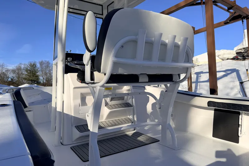 Slide: The Image of 2026 Tidewater 198 CC Adventure boat interior with seating and console, under clear blue sky. - 8