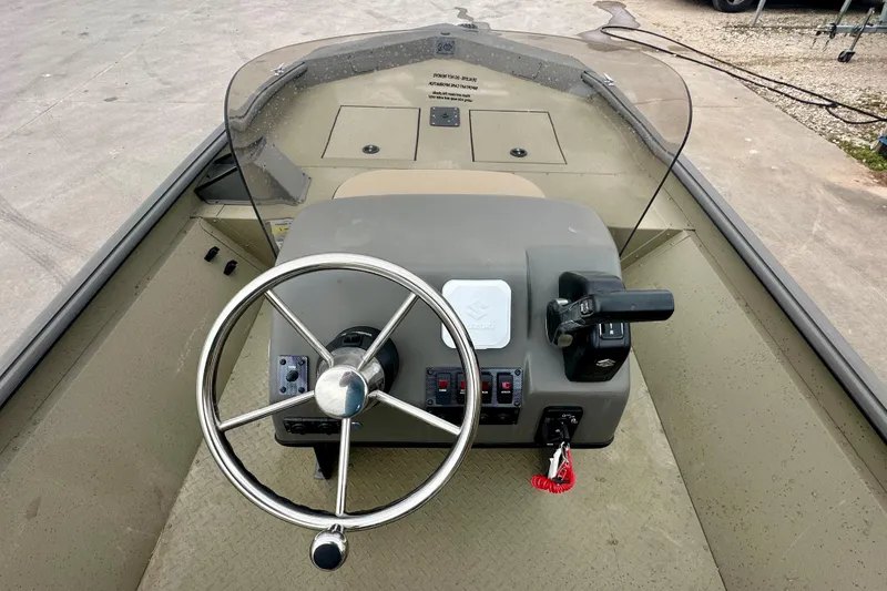 Slide: The Image of 2026 SeaArk Shadow 17 boat dashboard with steering wheel and controls. - 10