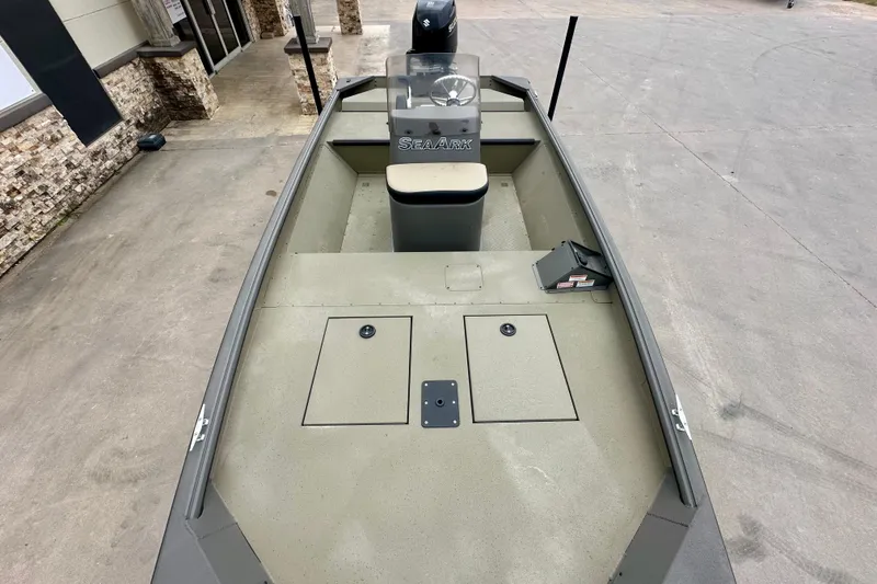 Slide: The Image of 2026 SeaArk Shadow 17 boat, spacious deck, modern design, parked outdoors. - 14