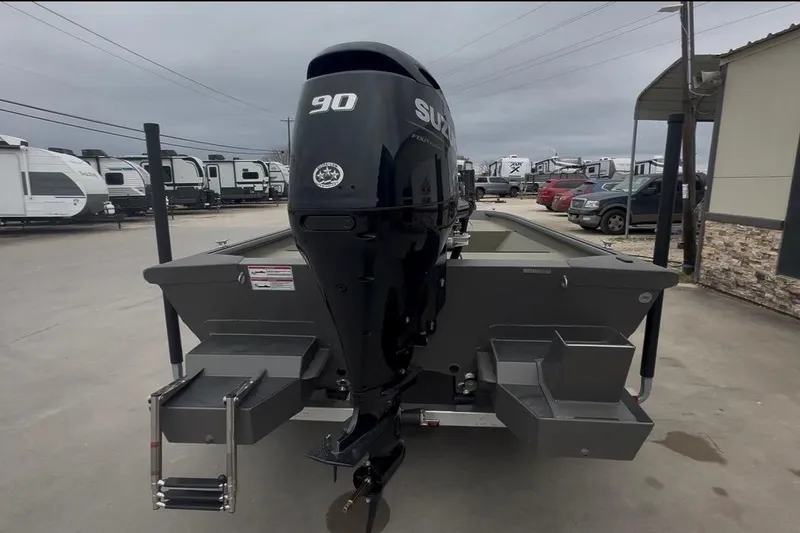 Slide: The Image of 2026 SeaArk Shadow 17 boat with 90 HP Suzuki engine, parked outdoors. - 5