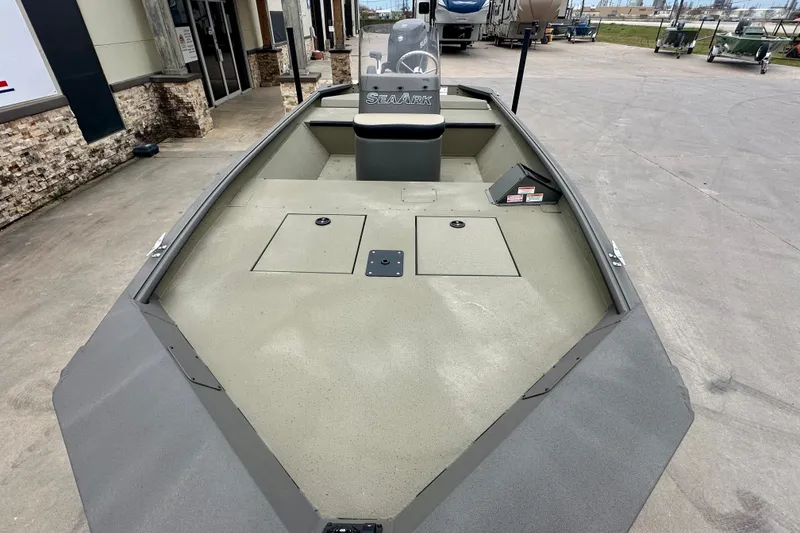 Slide: The Image of 2026 SeaArk Shadow 17 boat, spacious deck, modern design, parked outdoors. - 8