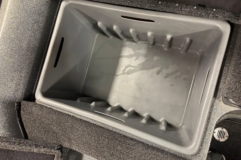 Slide: The Image of Storage compartment in a 2018 Nitro ZV21 boat, featuring a gray interior. - 12