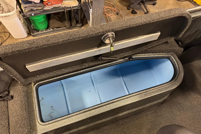 Slide: The Image of Open storage compartment in 2018 Nitro ZV21 boat, showing blue interior. - 13
