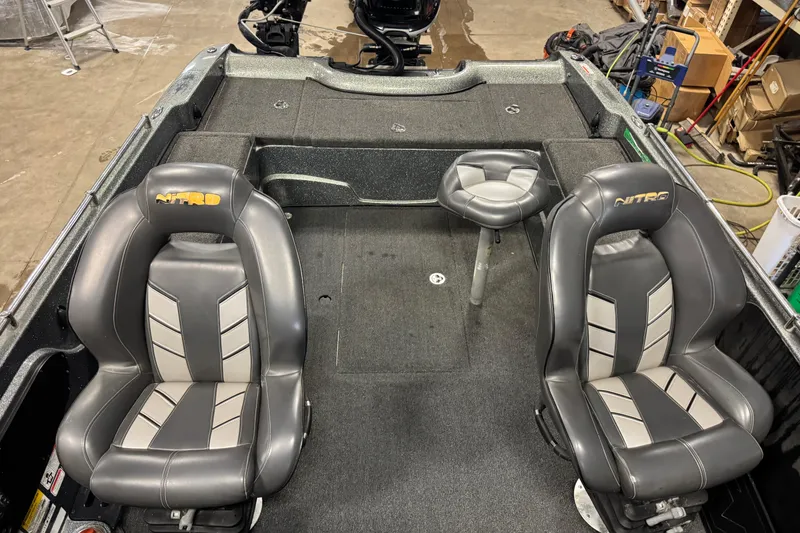 Slide: The Image of 2018 Nitro ZV21 boat interior with two cushioned seats and a central stool. - 14