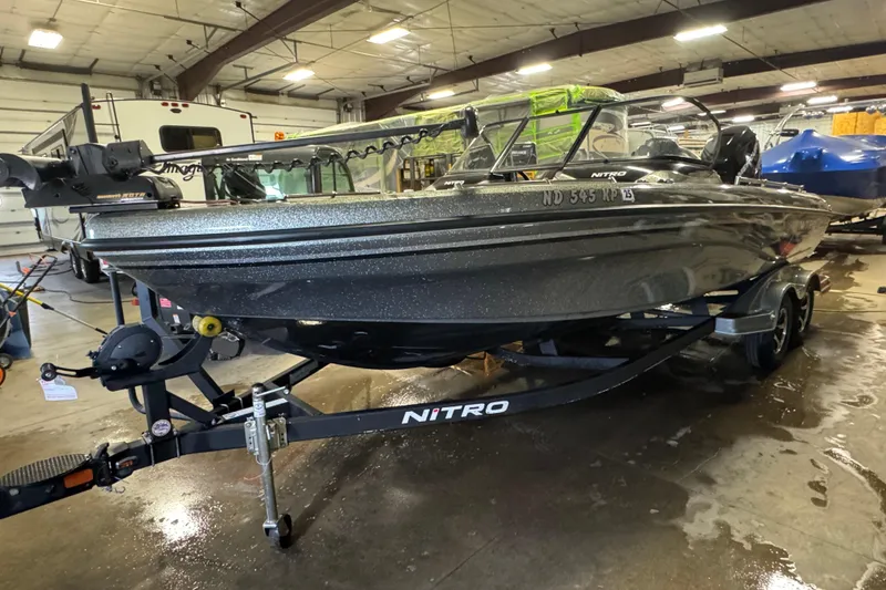 Slide: The Image of 2018 Nitro ZV21 boat on trailer in indoor storage facility. - 2
