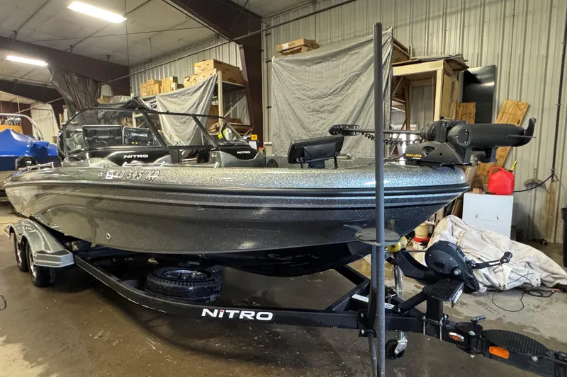 Slide: The Image of 2018 Nitro ZV21 boat in a garage, on a trailer, with equipment visible. - 3