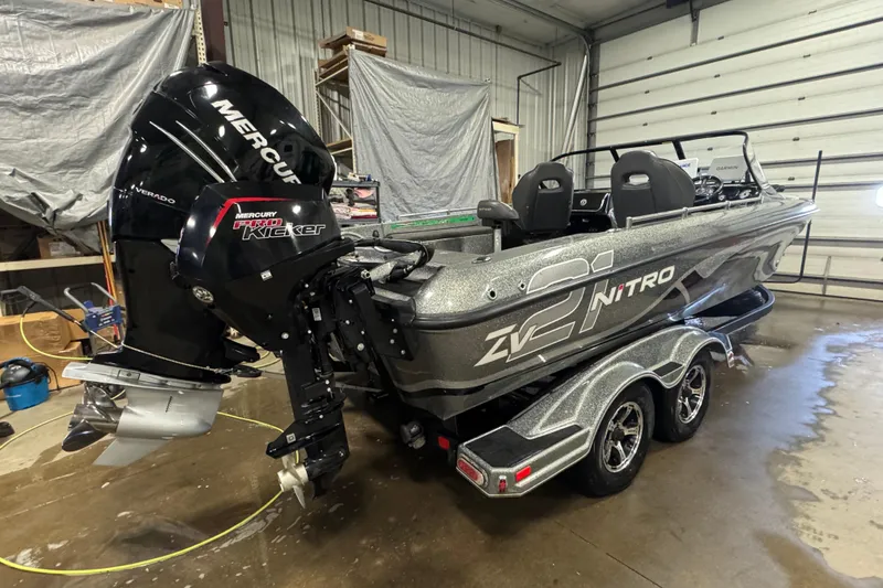 Slide: The Image of 2018 Nitro ZV21 boat with Mercury engines in a garage setting. - 4