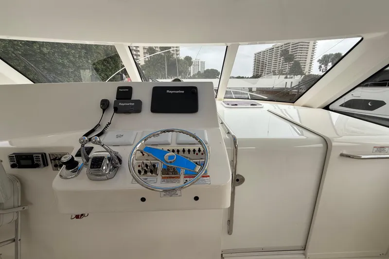 Slide: The Image of Helm of 2012 Cabo 40 Hardtop Express with Raymarine electronics and modern controls. - 5