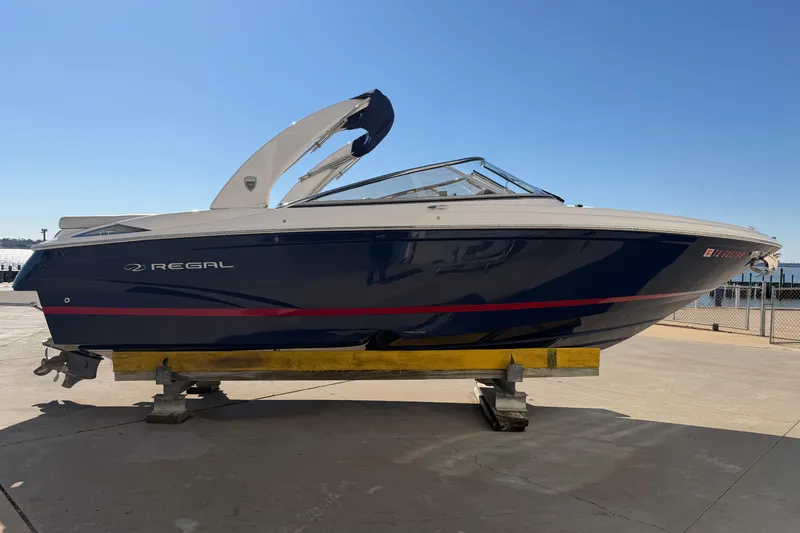 The Image of 2017 Regal 2700 ES Bowrider boat on a dock under clear blue sky. - 0