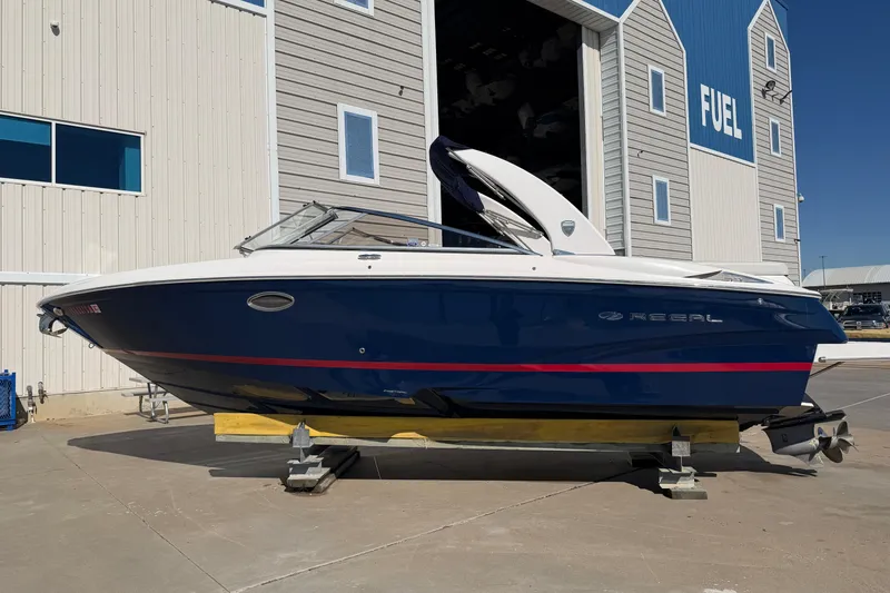 Slide: The Image of 2017 Regal 2700 ES Bowrider boat on display outside a fuel station. - 1