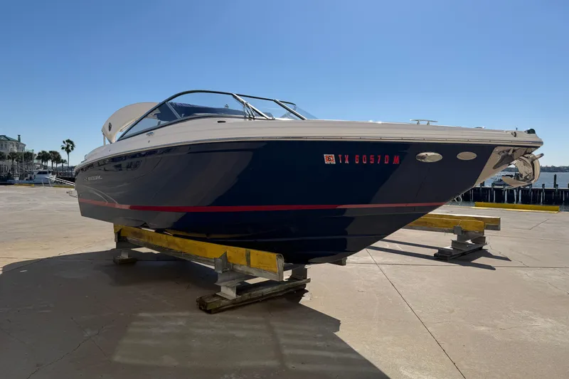 Slide: The Image of 2017 Regal 2700 ES Bowrider boat on dock, blue hull, sunny day. - 10